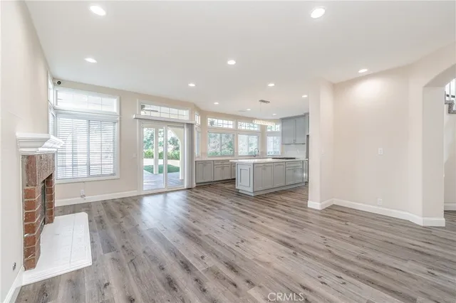 a view of kitchen with wooden floor and windows