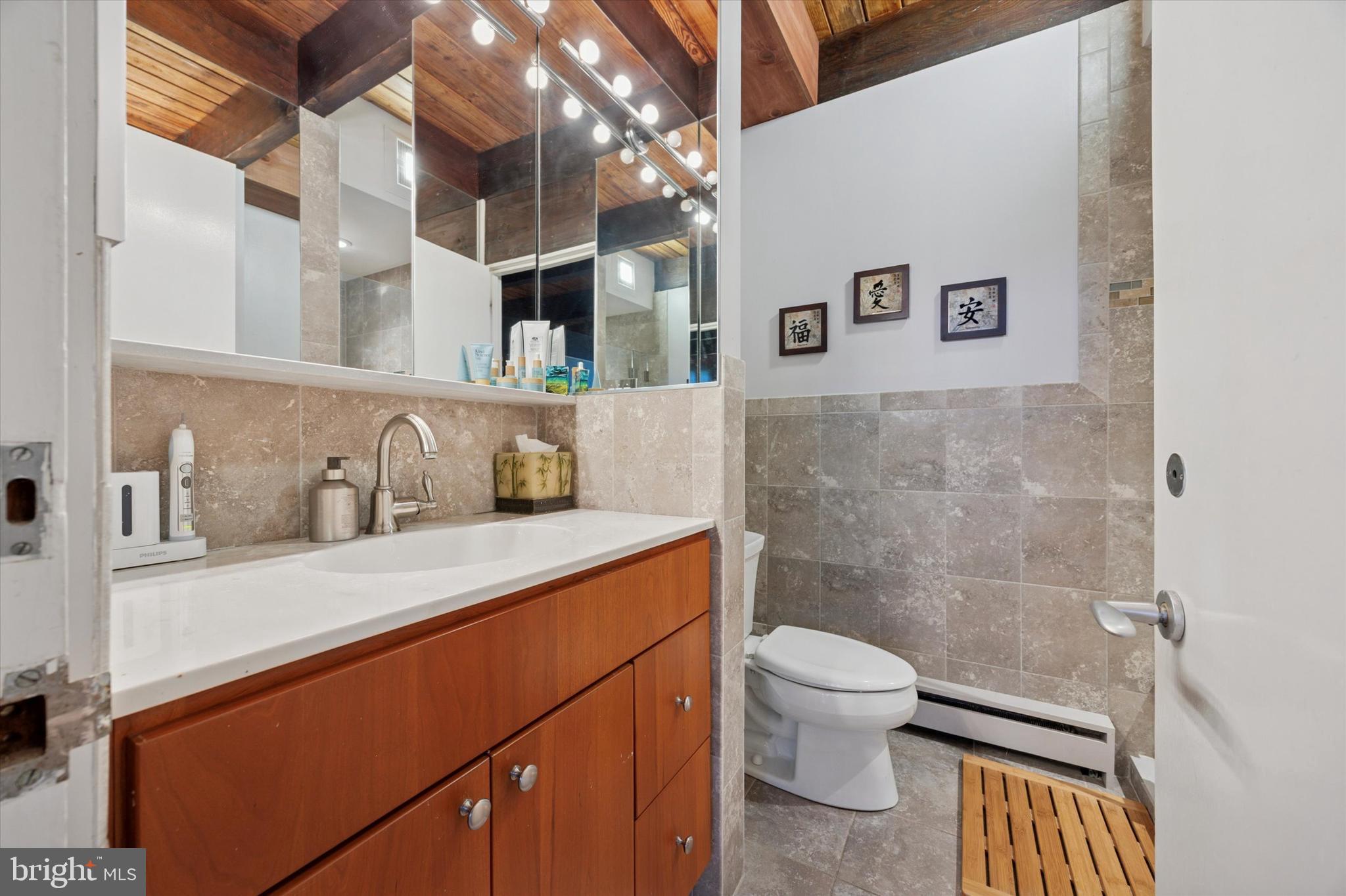 1430 Hopeland Road Wyncote, PA 19095 - Photo 24 of 37 a bathroom with a sink a toilet and a mirror