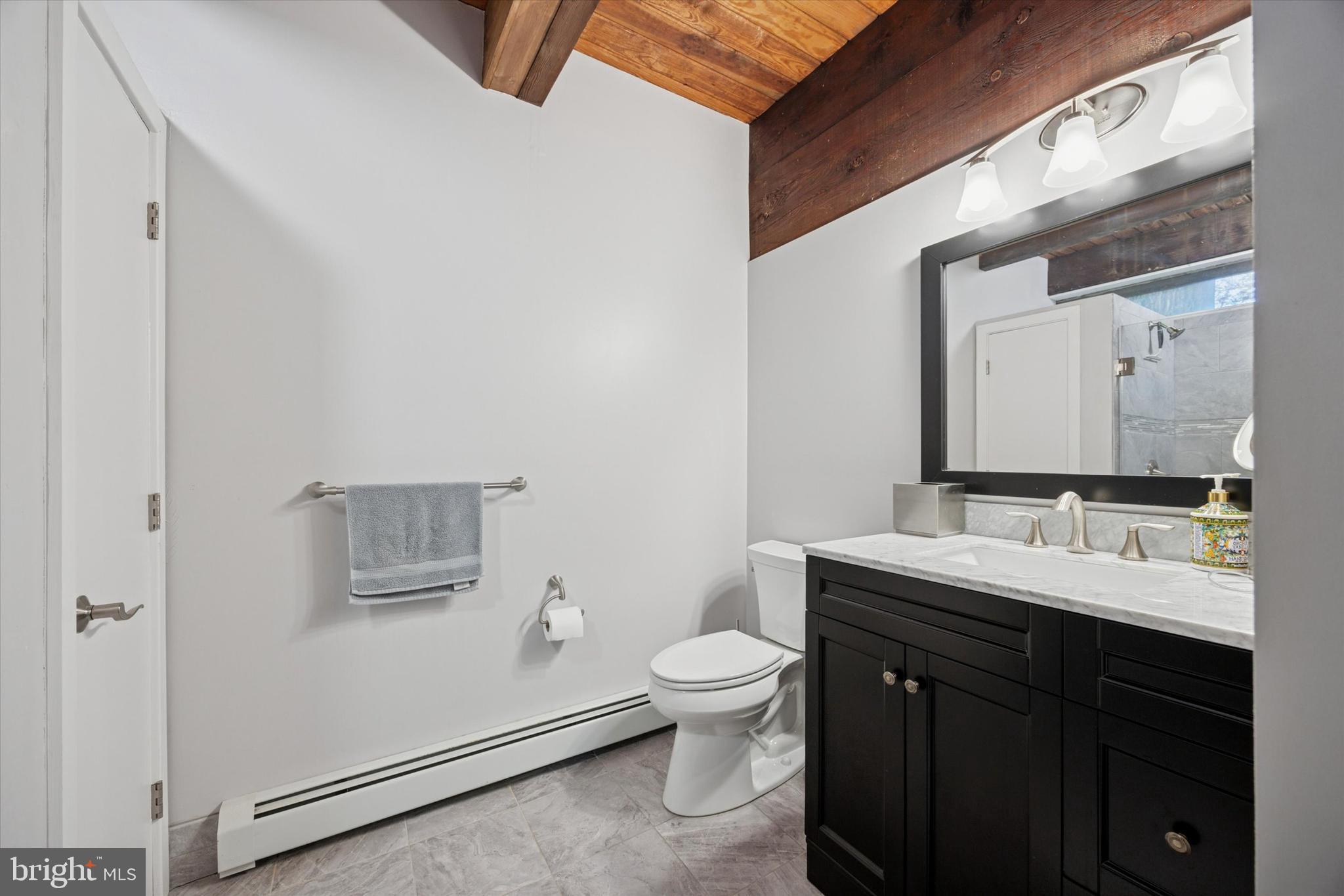 1430 Hopeland Road Wyncote, PA 19095 - Photo 28 of 37 a bathroom with a toilet a sink and a mirror