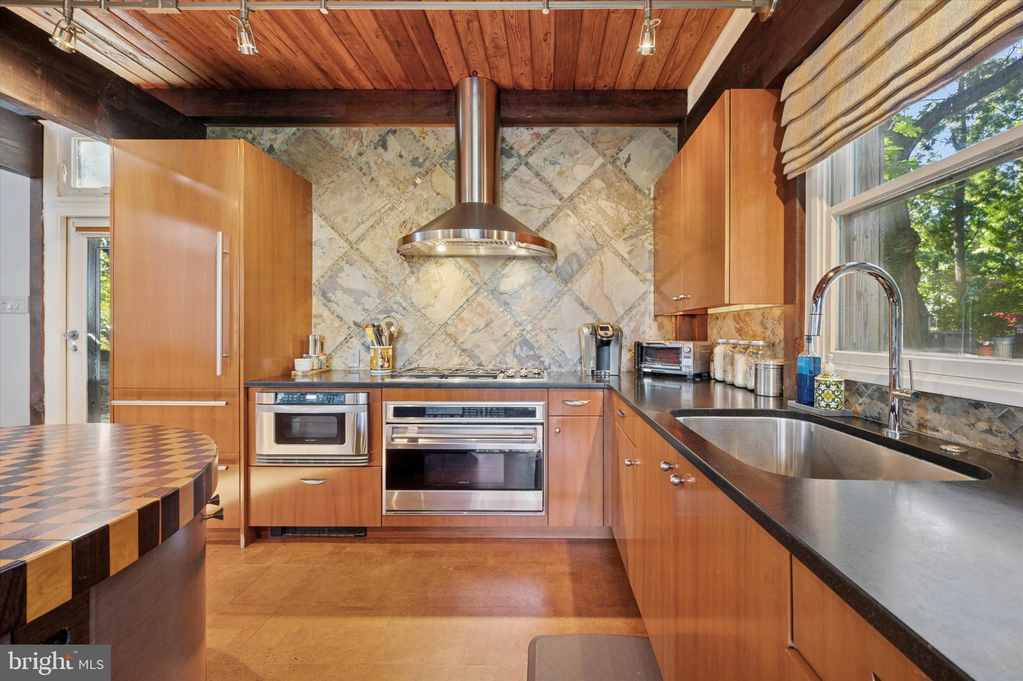 1430 Hopeland Road Wyncote, PA 19095 - Photo 4 of 37 a kitchen with stainless steel appliances granite countertop a sink and a granite counter tops with a large window