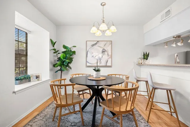 a view of a dining room with furniture and window