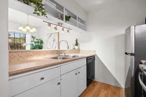 a bathroom with a double vanity sink and mirror