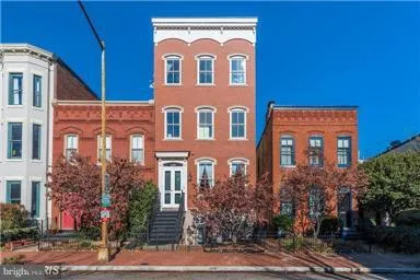 a view of a brick building with large windows
