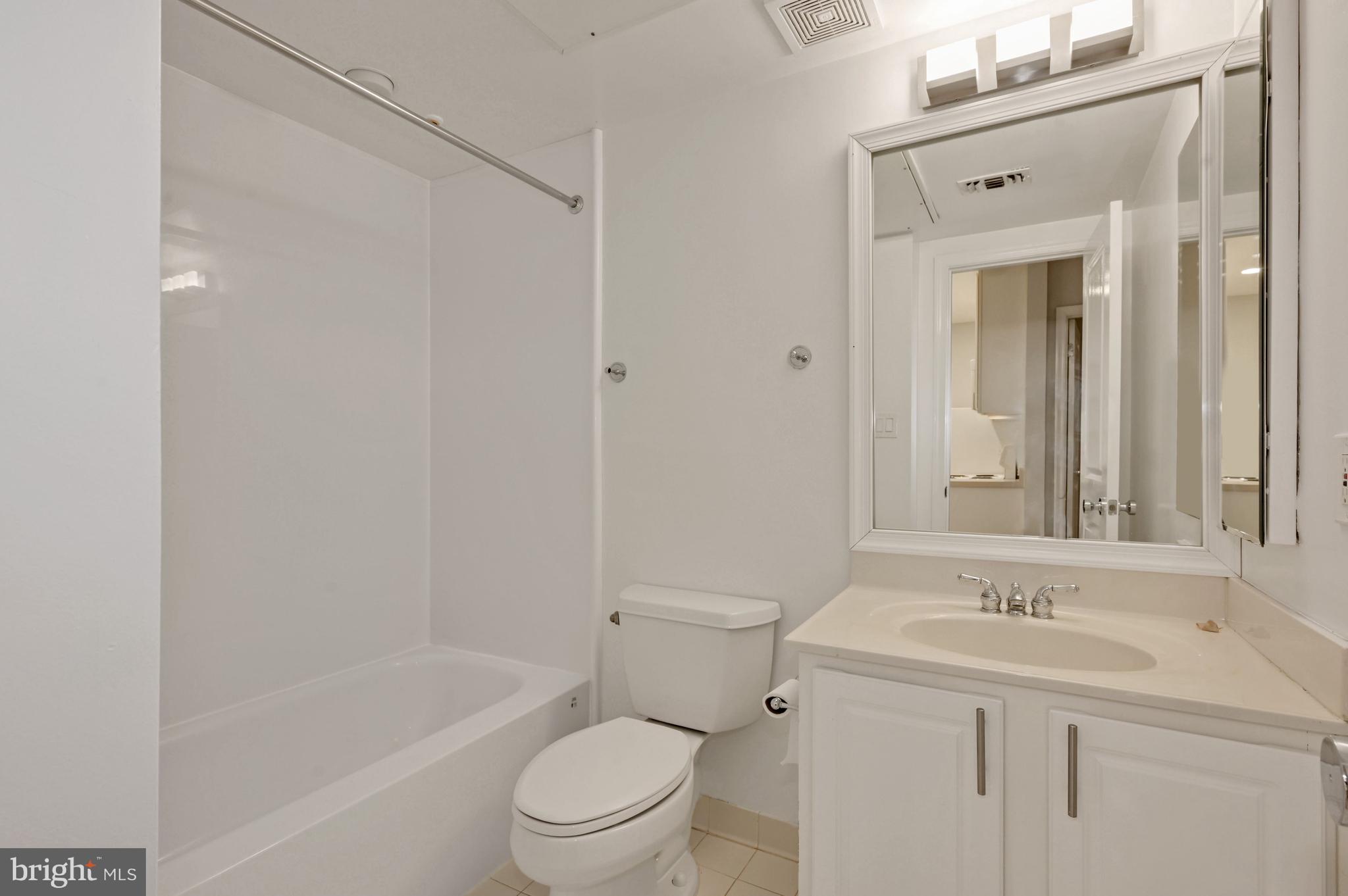 648 C Street Northeast, Unit 1 Washington, DC 20002 - Photo 12 of 17 a bathroom with a sink a toilet and shower