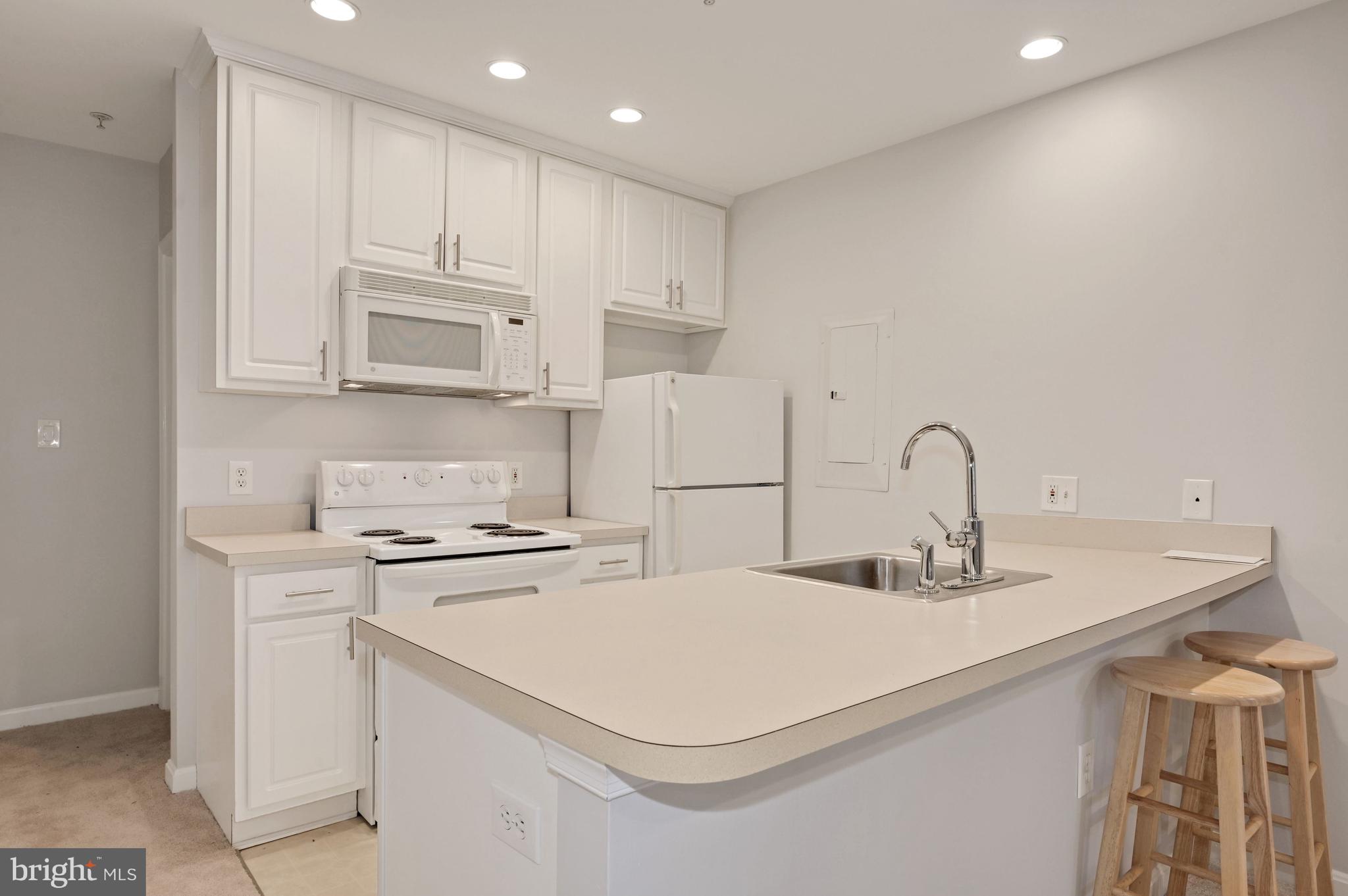 648 C Street Northeast, Unit 1 Washington, DC 20002 - Photo 7 of 17 a kitchen with a sink a stove and cabinets