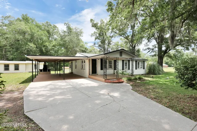 a front view of a house with yard patio and green space