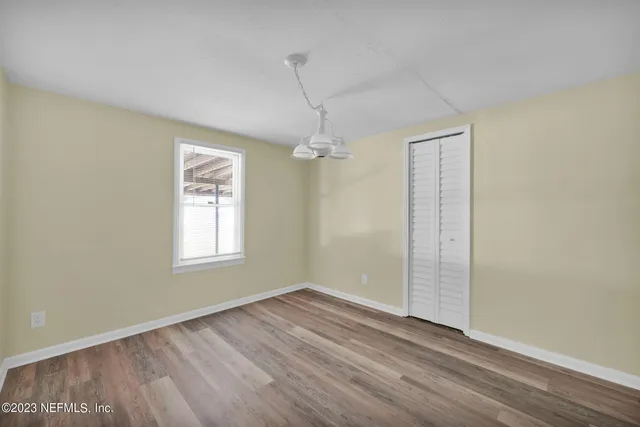 wooden floor in an empty room with a window