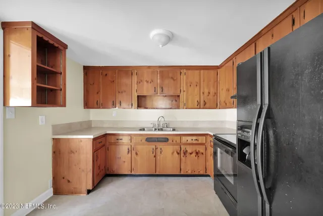 a kitchen with a sink stove and refrigerator