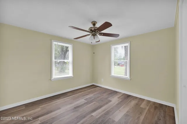 a view of a livingroom with a window and a ceiling fan