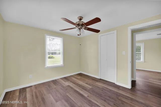 a view of a livingroom with a hardwood floor and a ceiling fan