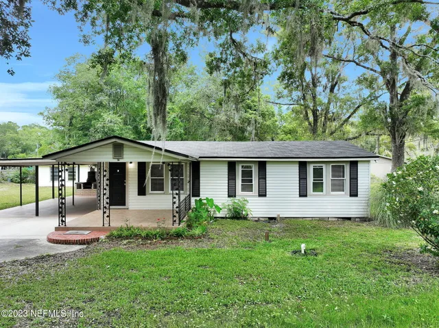 a front view of house with yard and green space