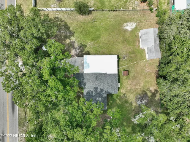 a brick building with a yard in front of it