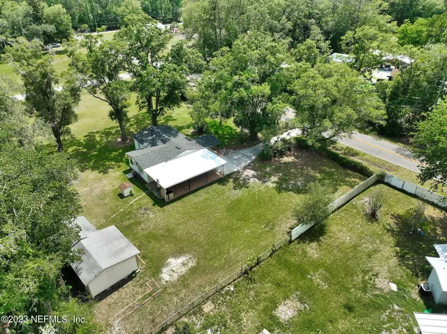 an aerial view of a house with a yard