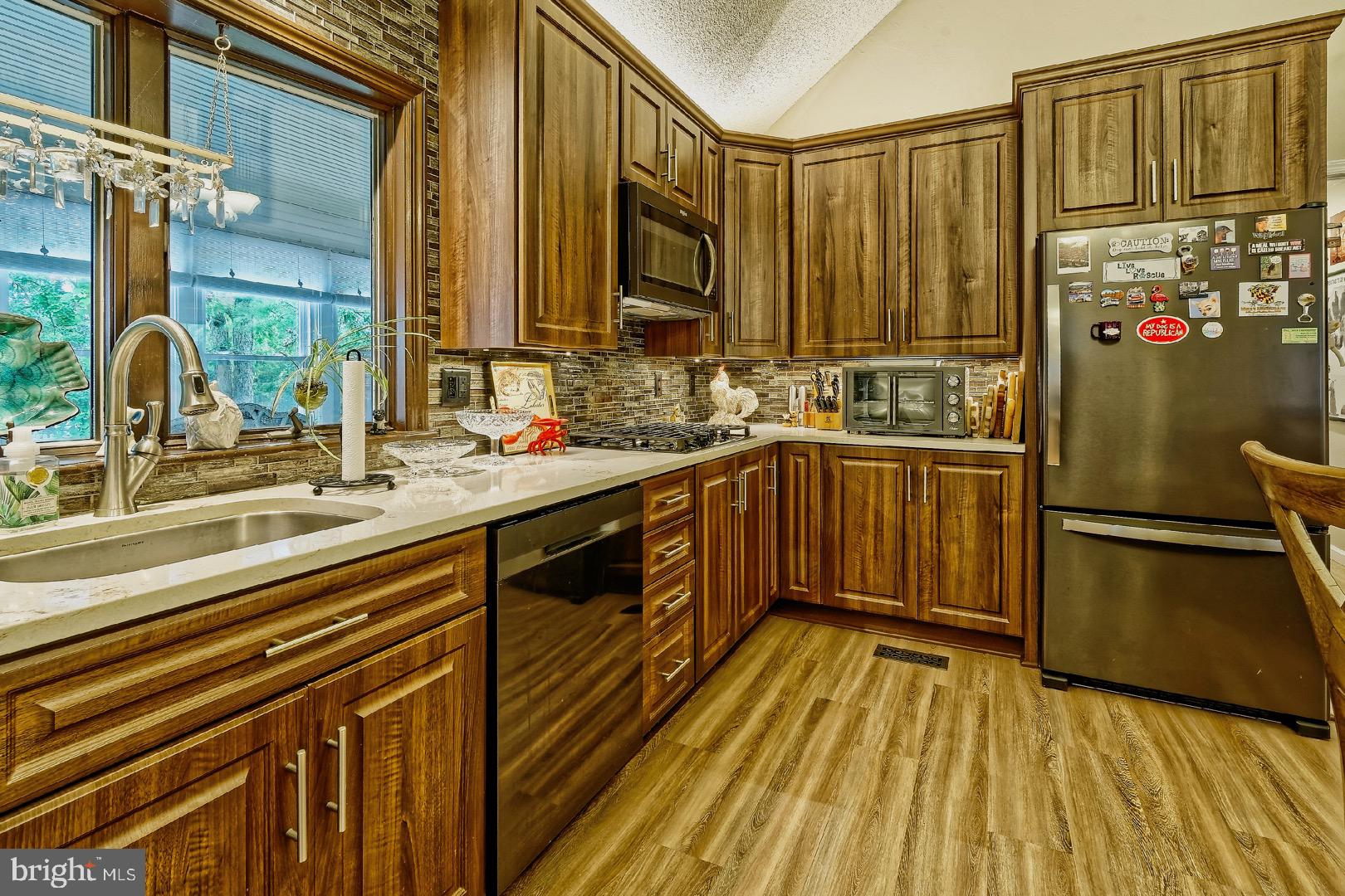 84 Jennings Road Manahawkin, NJ 08050 - Photo 11 of 40 a kitchen with sink a refrigerator and wooden floor