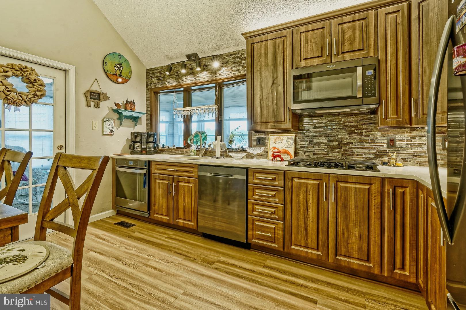 84 Jennings Road Manahawkin, NJ 08050 - Photo 13 of 40 a kitchen with stainless steel appliances granite countertop a stove a sink and a microwave