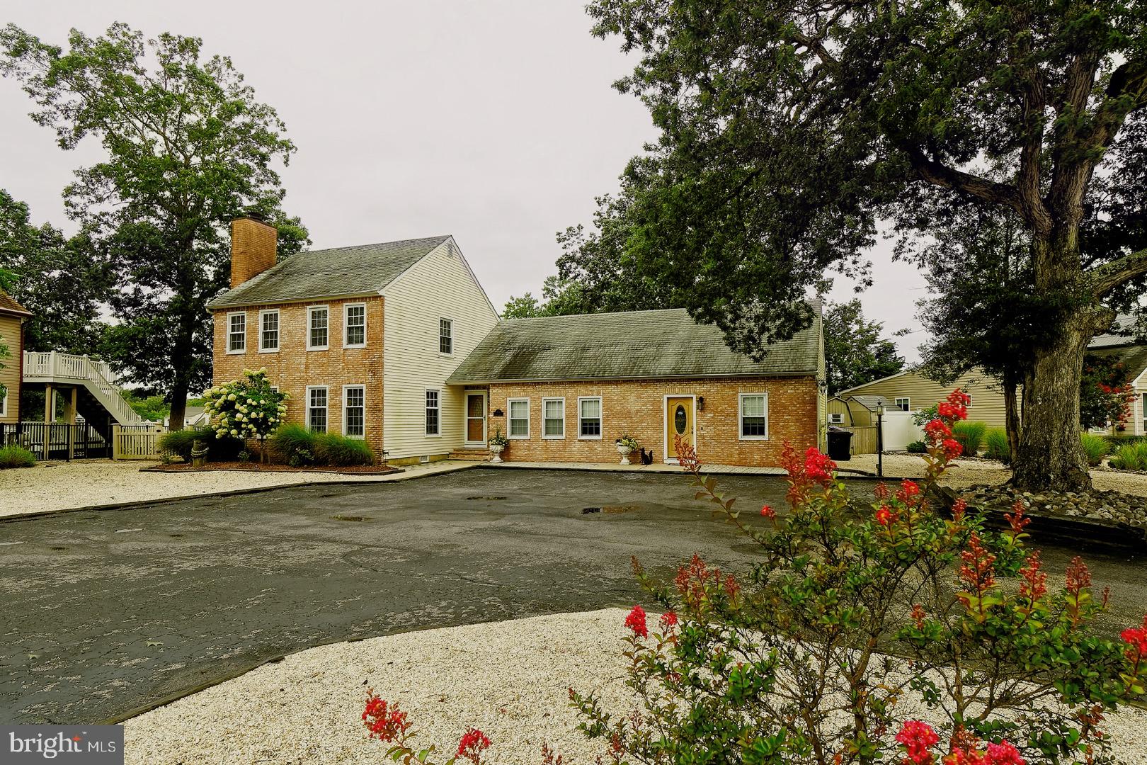 84 Jennings Road Manahawkin, NJ 08050 - Photo 2 of 40 a front view of a house with a yard and garage
