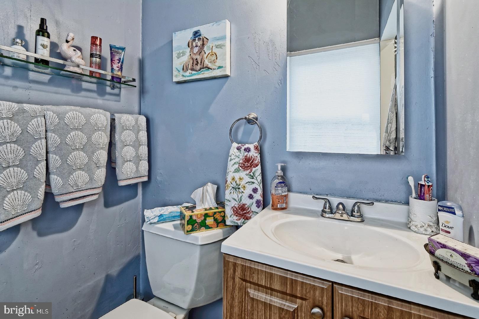 84 Jennings Road Manahawkin, NJ 08050 - Photo 27 of 40 a bathroom with a sink mirror vanity and toilet
