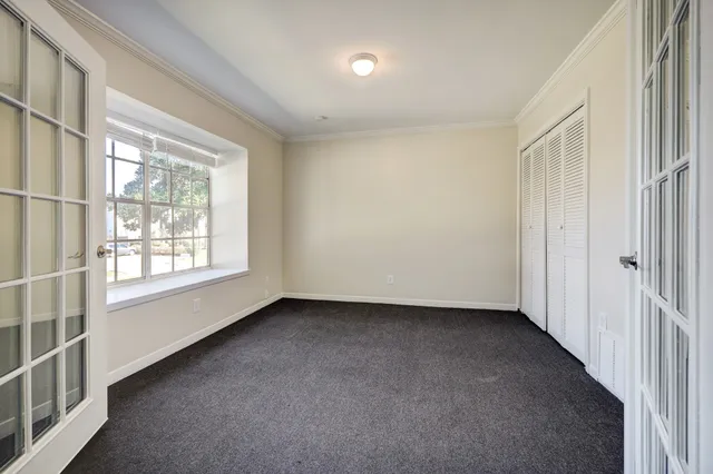 a view of a livingroom with an empty space and a window