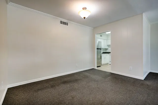 an empty room with a empty space and windows