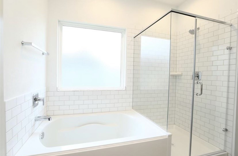 7311 Ramsgate Cliff Lane Richmond, TX 77407 - Photo 8 of 21 a bathroom with a shower and a bath tub