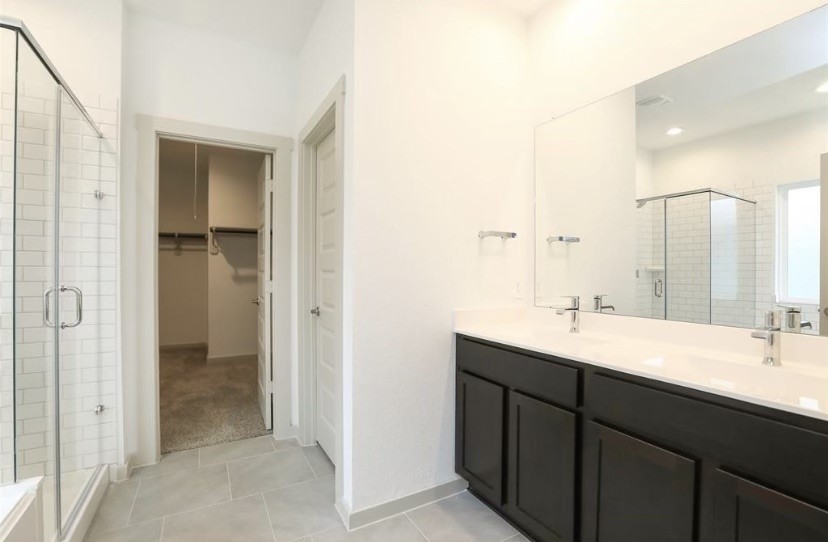 7311 Ramsgate Cliff Lane Richmond, TX 77407 - Photo 9 of 21 a bathroom with a double vanity sink and mirror