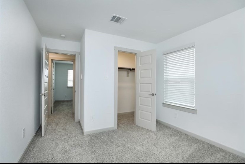 7311 Ramsgate Cliff Lane Richmond, TX 77407 - Photo 10 of 21 an empty room with windows and closet