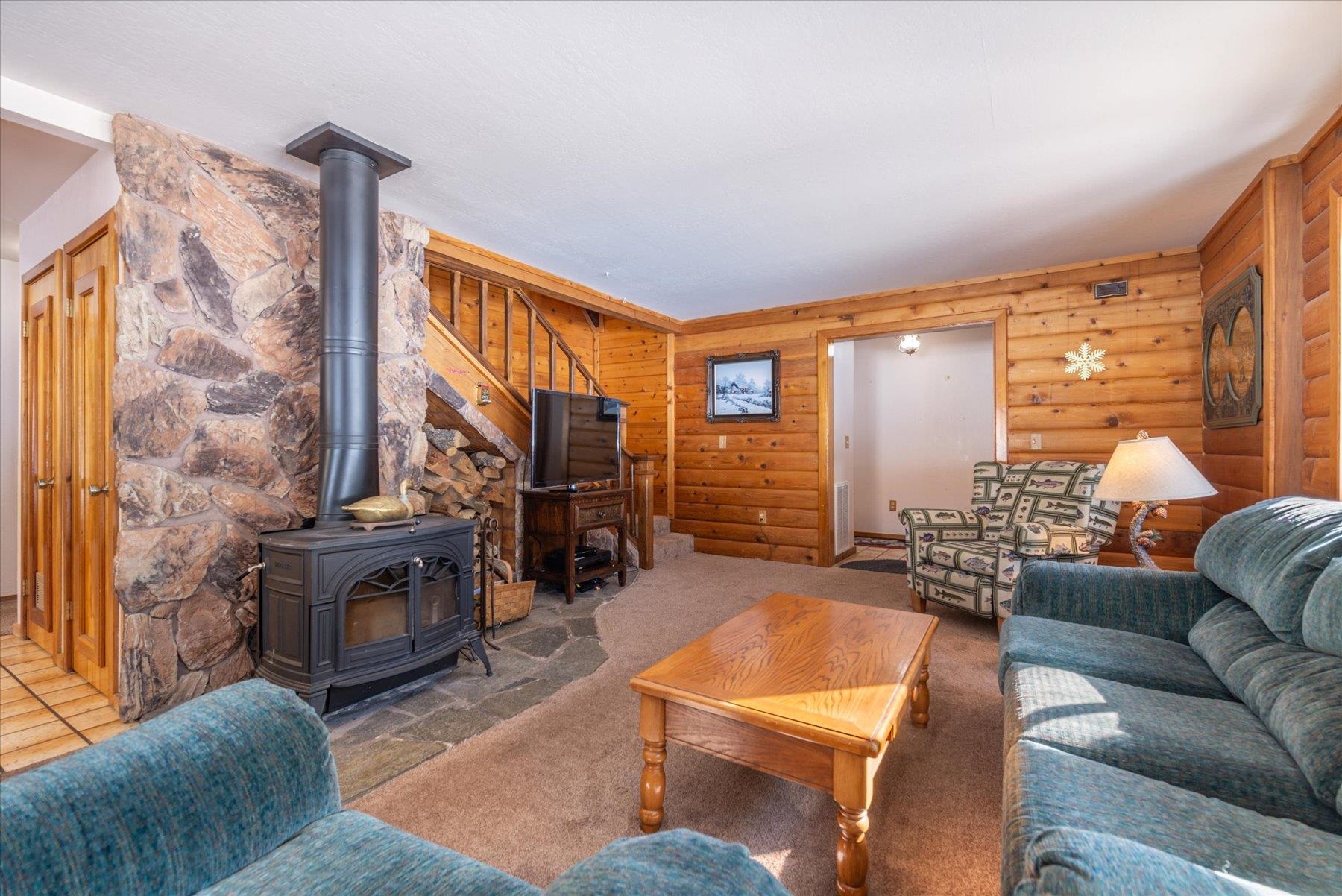 17080 Ski Slope Way Truckee, CA 96161 - Photo 2 of 22 a living room with furniture a rug and a fireplace