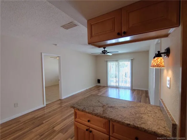 a kitchen with granite countertop wooden cabinets and a granite counter tops