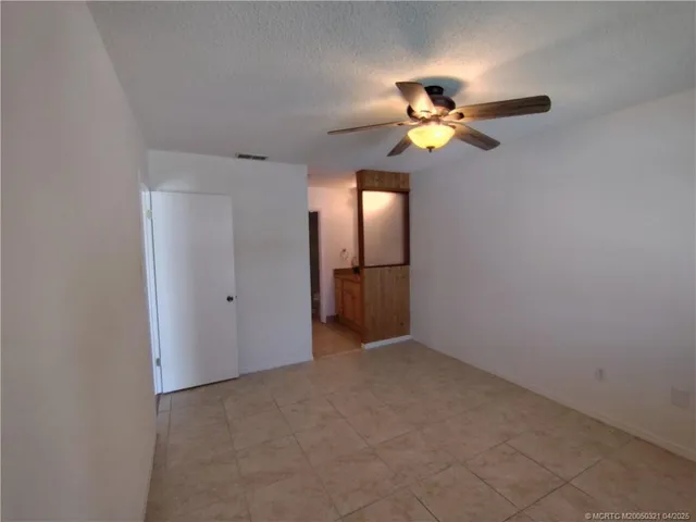 a view of an empty room with a fan