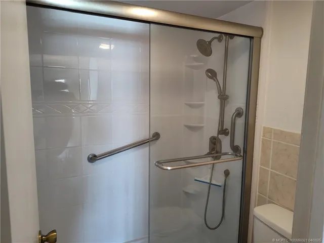 a bathroom with a glass shower door