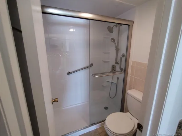 a bathroom with a toilet and a shower