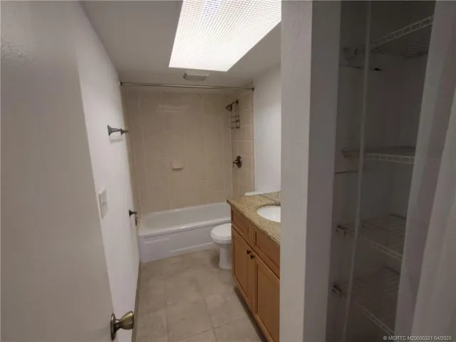 a bathroom with a tub shower vanity and a sink