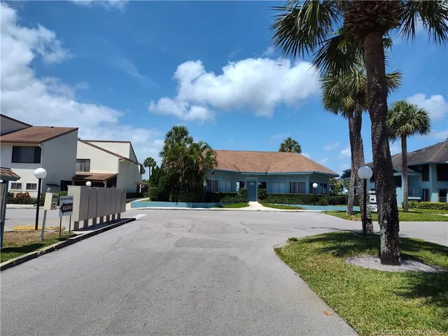 a front view of a house with yard and tree s