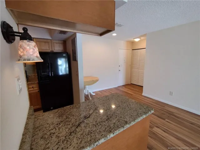 a view of a hallway of a house with wooden floor