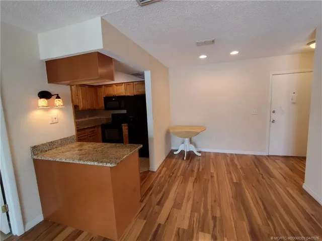 a room with wooden floor and a sink