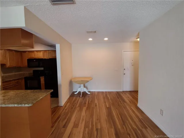 a view of a living room with wooden floor