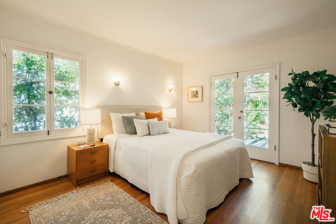 2101 Lambert Drive Pasadena, CA 91107 - Photo 24 of 48 a bedroom with a large bed and a large window with wooden floor