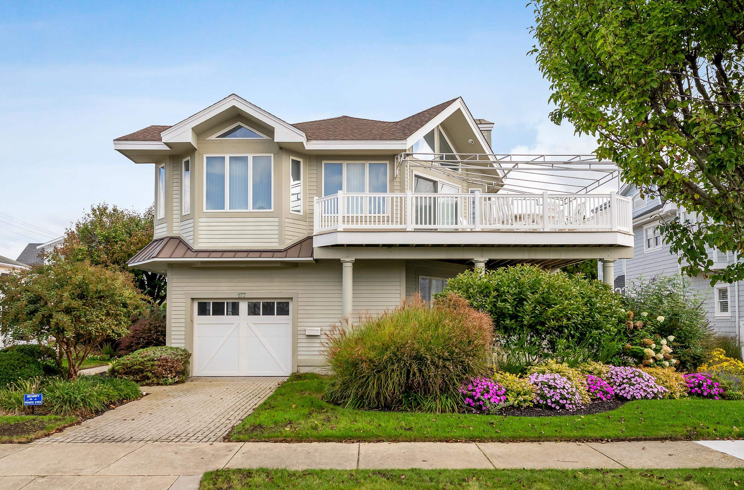 177 71st Street Avalon, NJ 08202 - Photo 1 of 44 a front view of a house with a garden