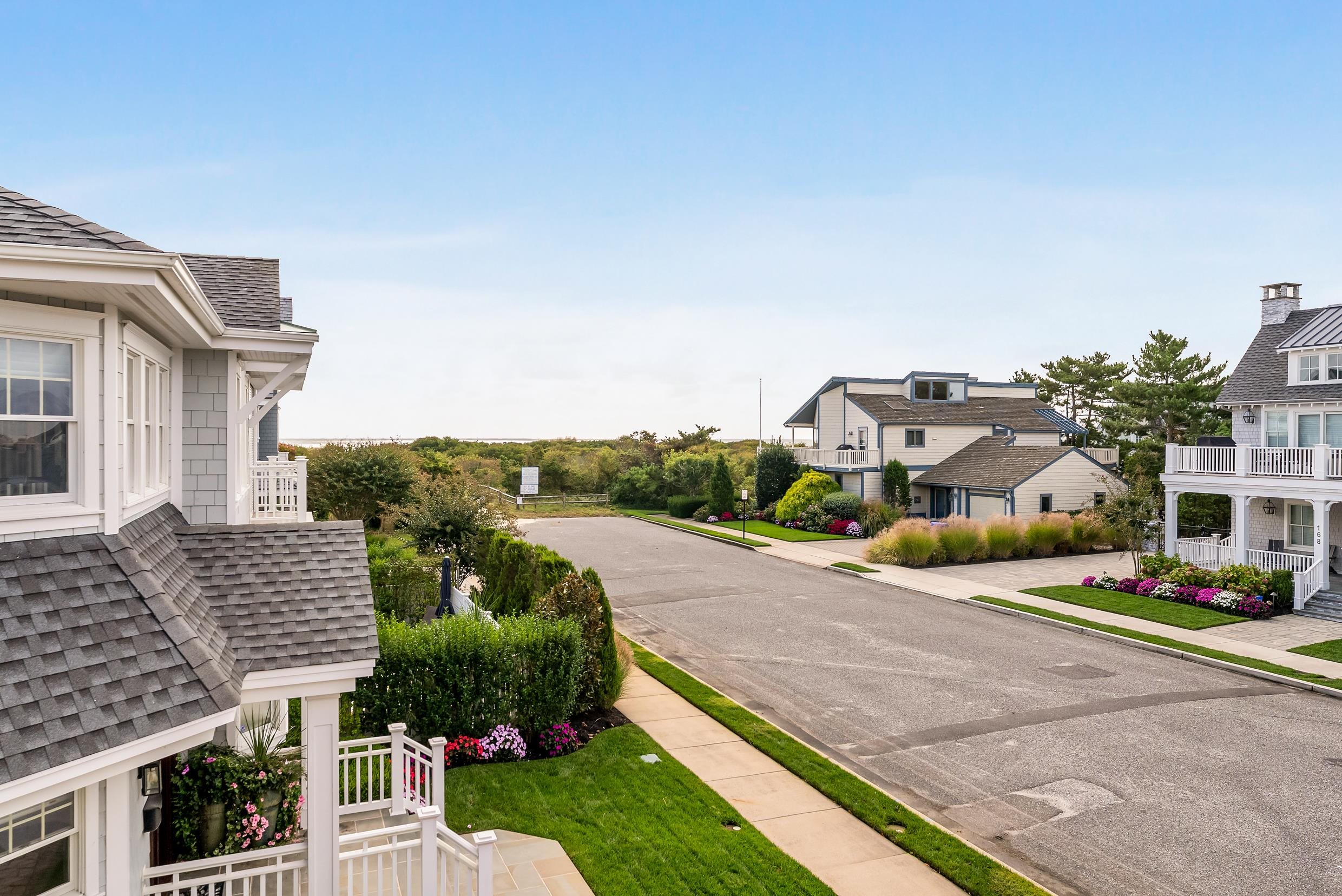 177 71st Street Avalon, NJ 08202 - Photo 24 of 44 a front view of a house with a yard and table and chairs