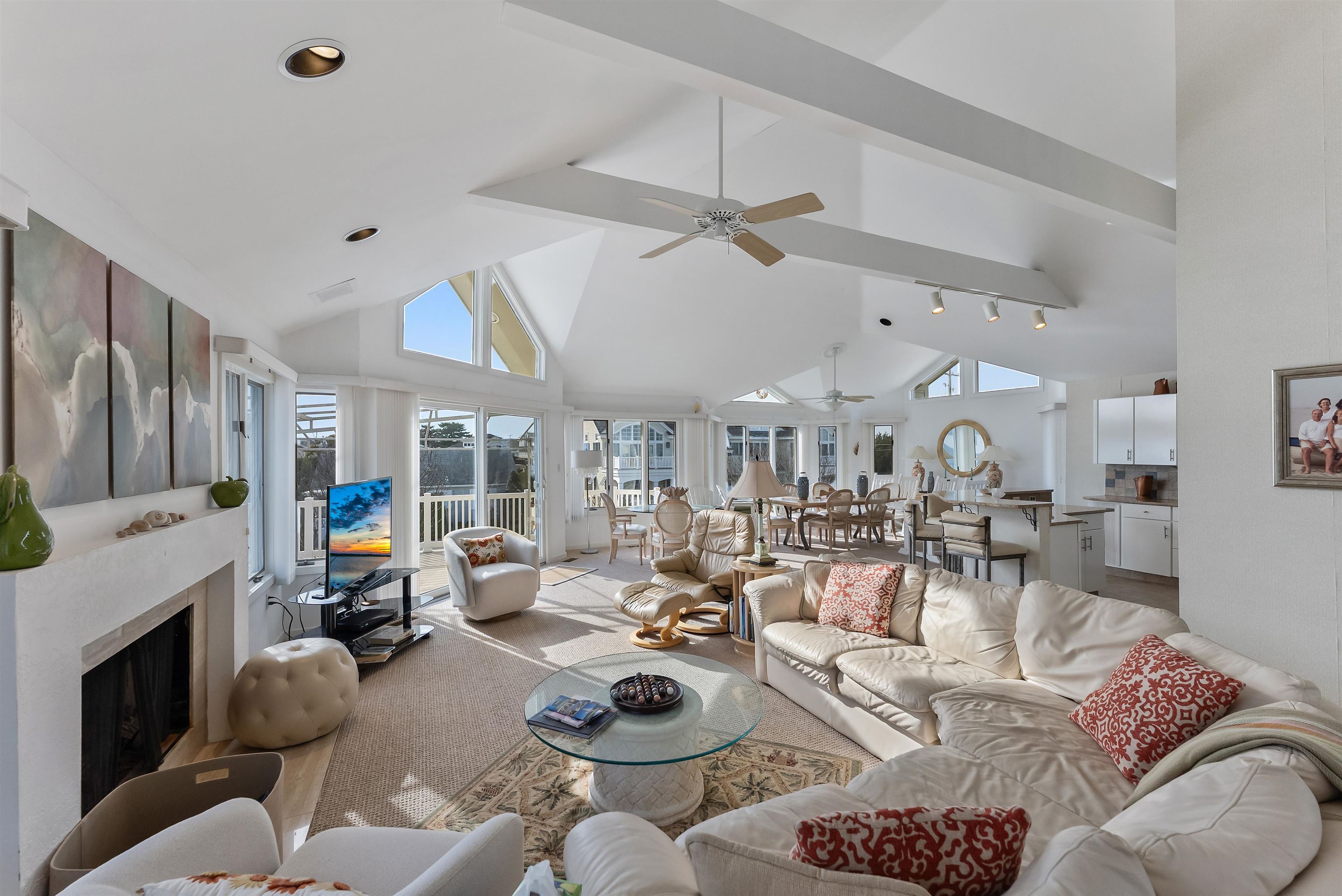 177 71st Street Avalon, NJ 08202 - Photo 26 of 44 a living room with furniture a fireplace and a flat screen tv