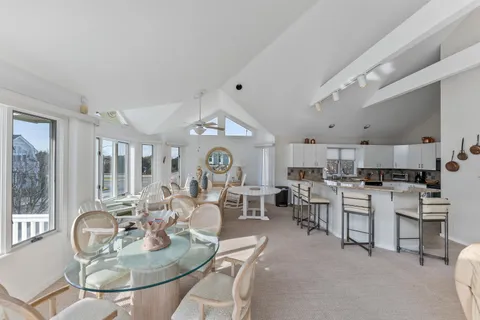 a very nice looking open dining room with kitchen island furniture and a large window