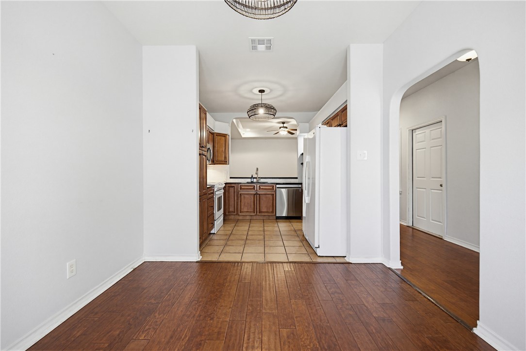 7251 Prairie Drive, Unit 6 Corpus Christi, TX 78413 - Photo 7 of 28 a view of a hallway with wooden floor and a kitchen