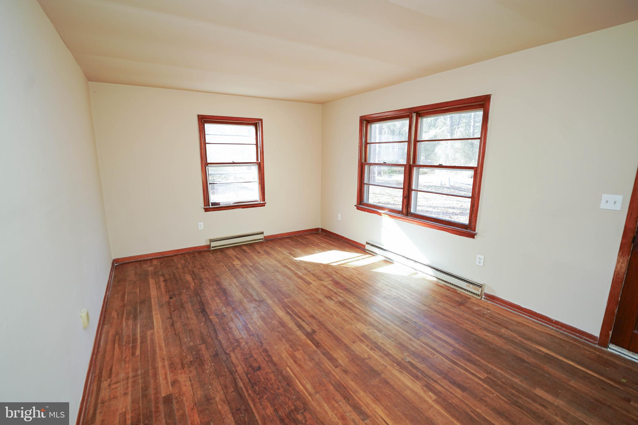 5643 Rip Wil Drive Salisbury, MD 21804 - Photo 11 of 34 an empty room with wooden floor and windows