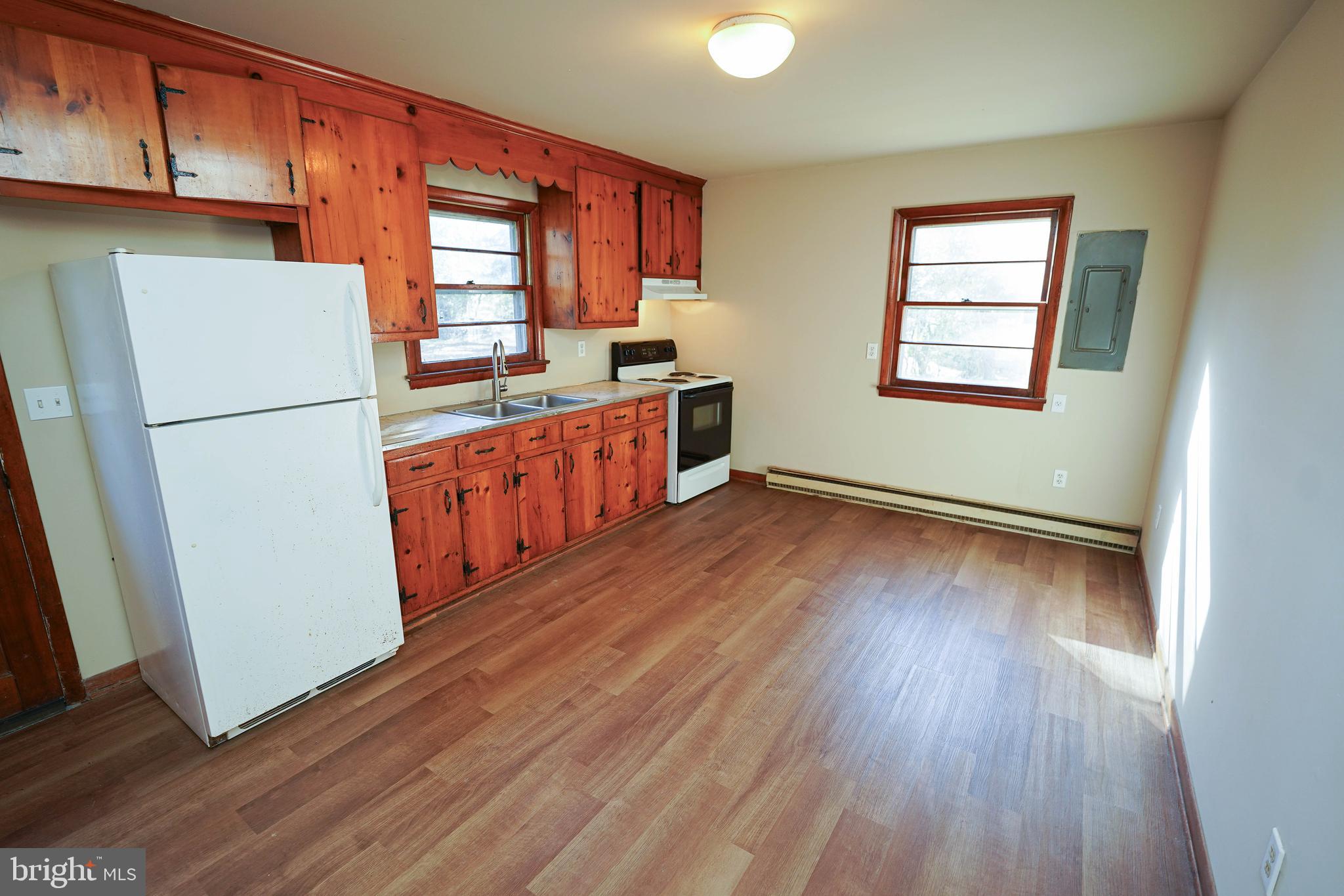 5643 Rip Wil Drive Salisbury, MD 21804 - Photo 12 of 34 a kitchen with wooden floors and white appliances