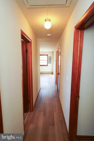 a view of a hallway with wooden floor