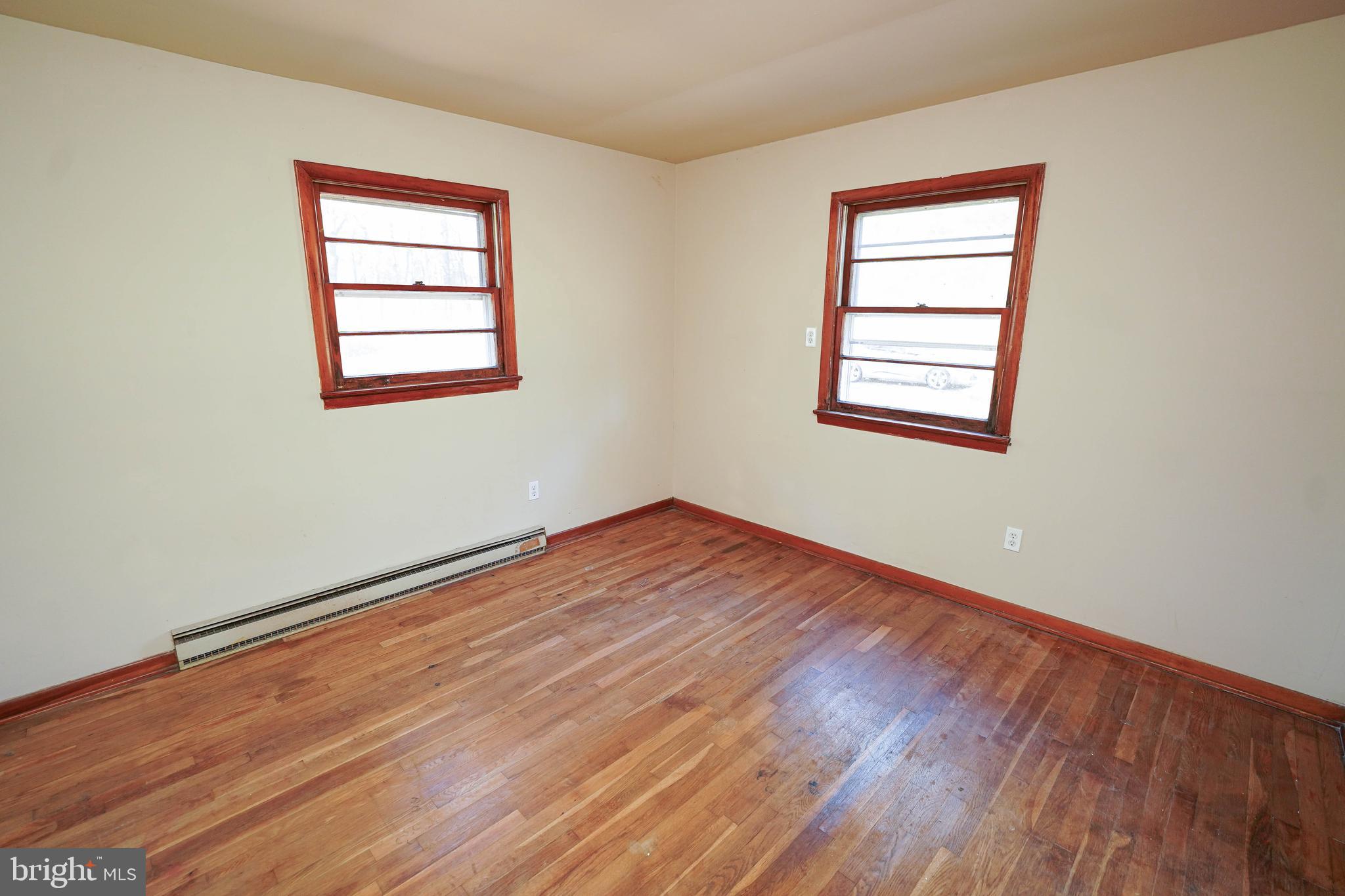 5643 Rip Wil Drive Salisbury, MD 21804 - Photo 20 of 34 an empty room with wooden floor and windows