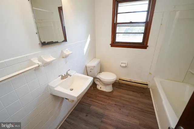 a bathroom with a toilet sink and mirror