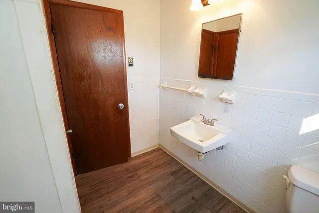 a bathroom with a sink toilet and mirror