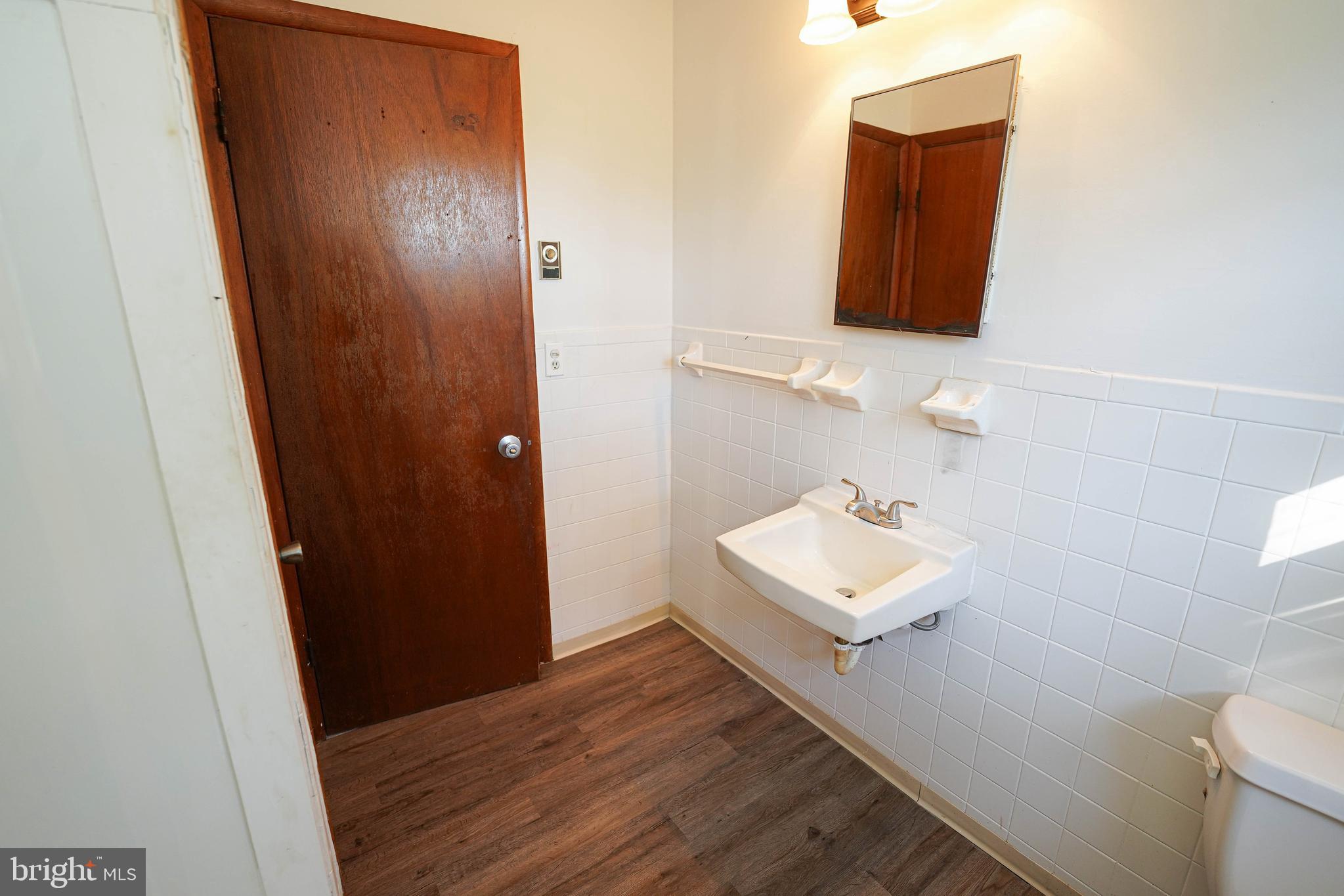 5643 Rip Wil Drive Salisbury, MD 21804 - Photo 25 of 34 a bathroom with a sink toilet and mirror