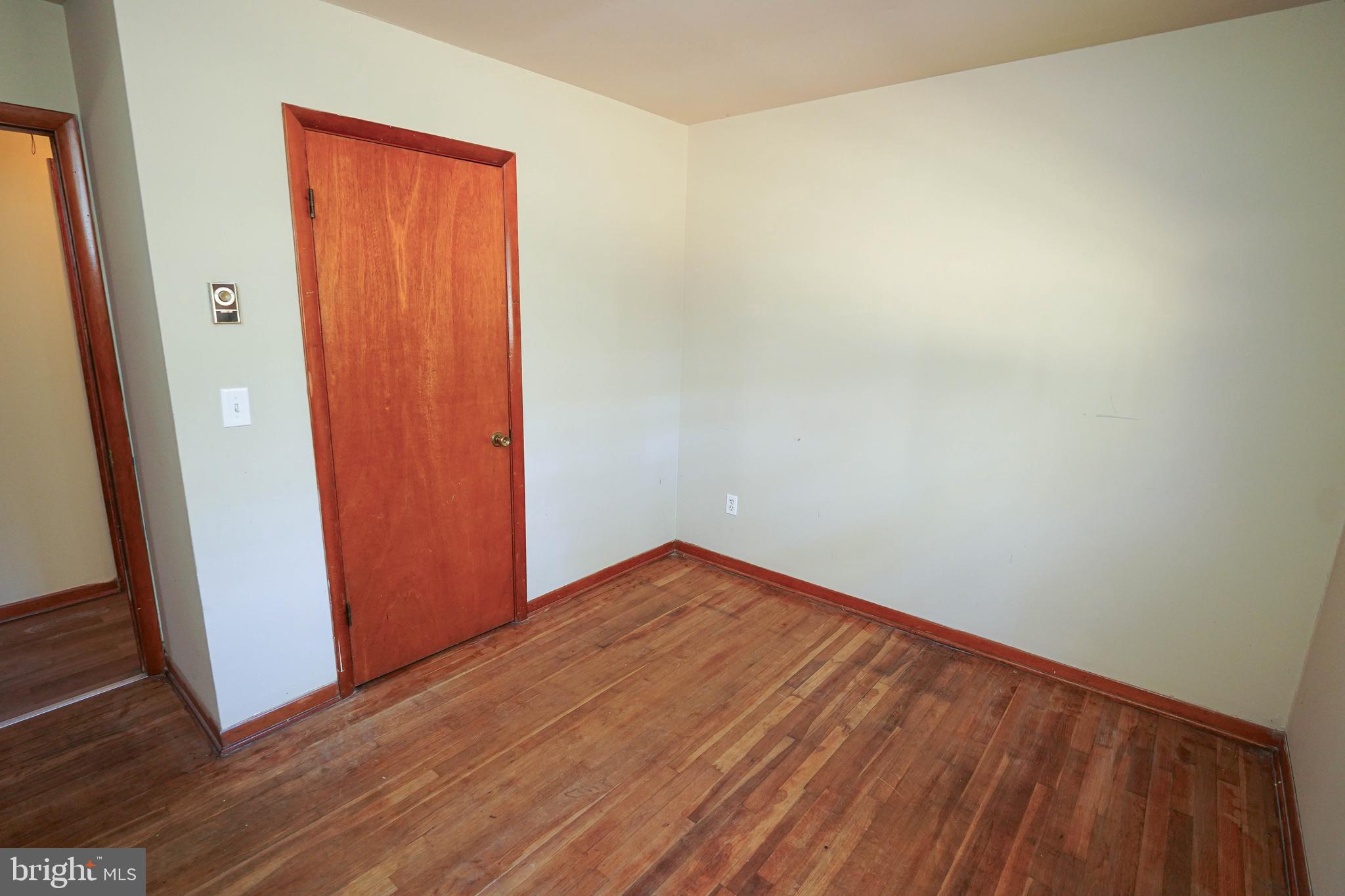 5643 Rip Wil Drive Salisbury, MD 21804 - Photo 32 of 34 an empty room with wooden floor and door